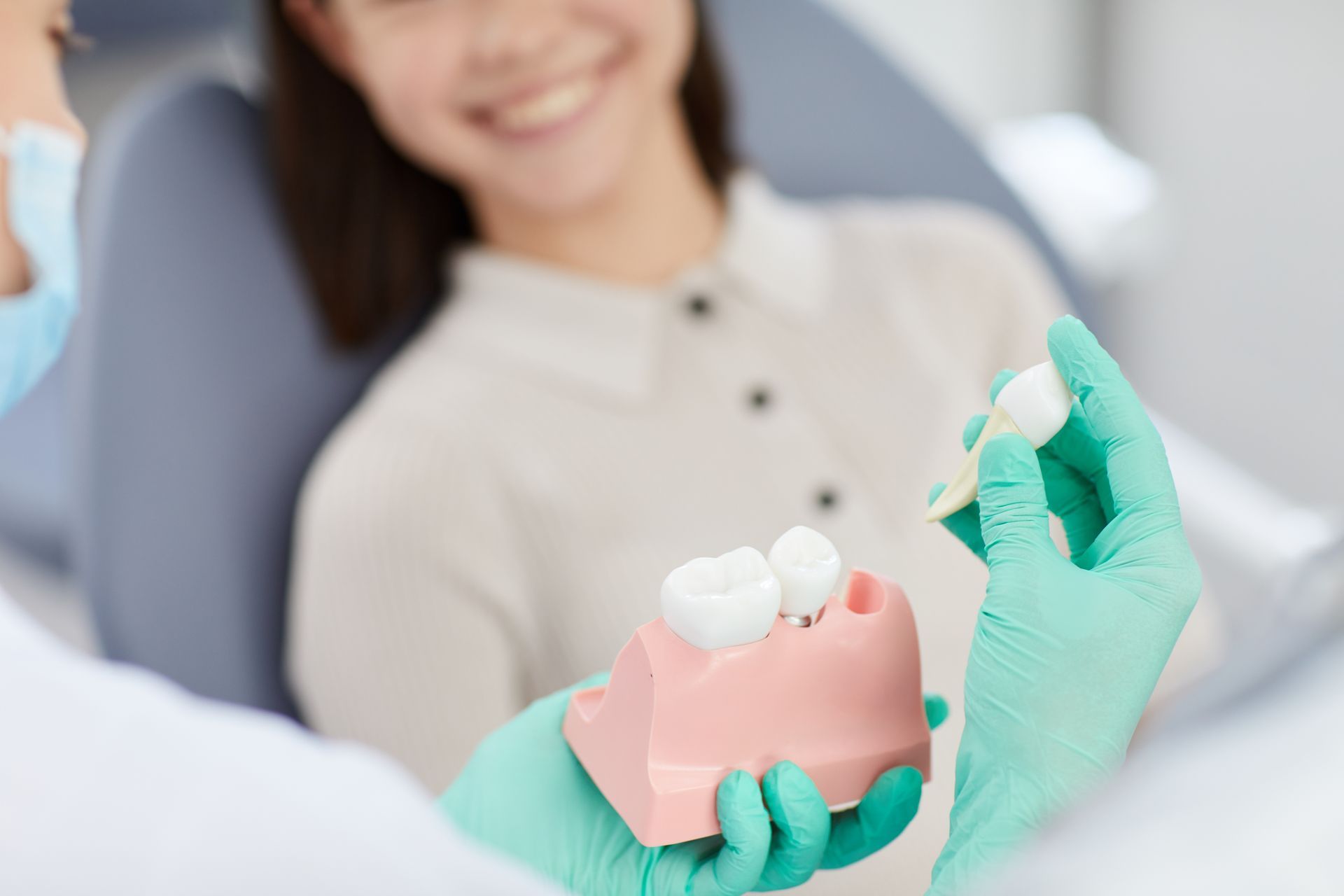A dentist is examining a patient 's teeth in a dental office.