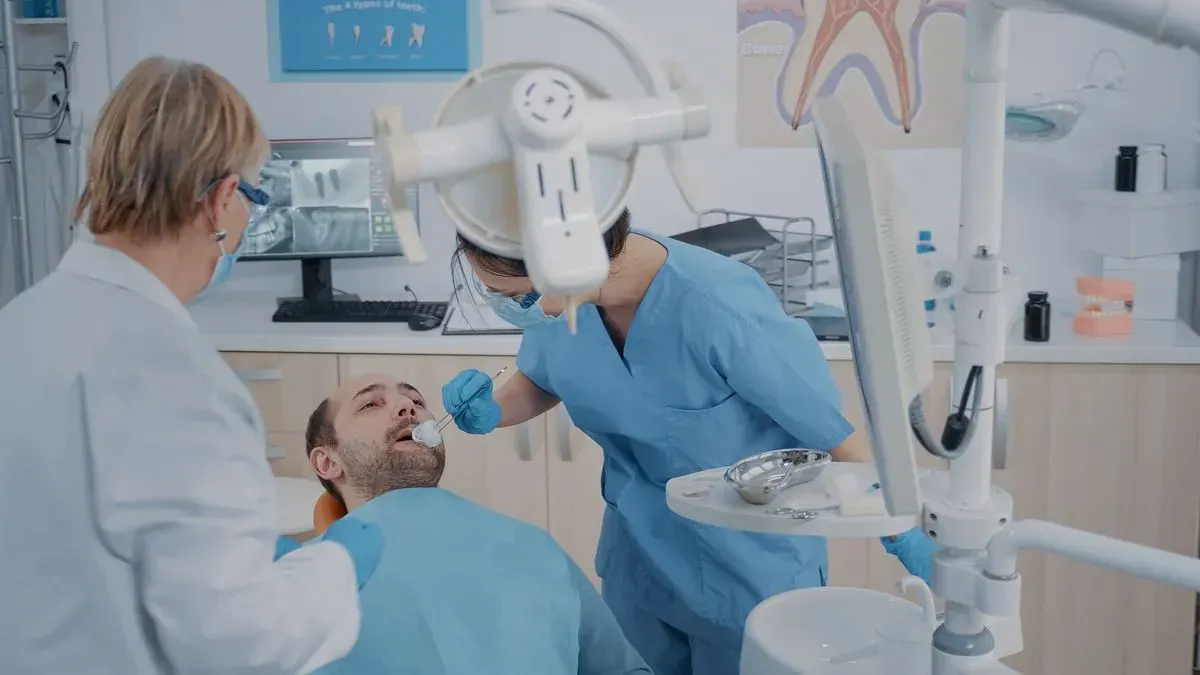 A dentist is examining a patient 's teeth in a dental office.