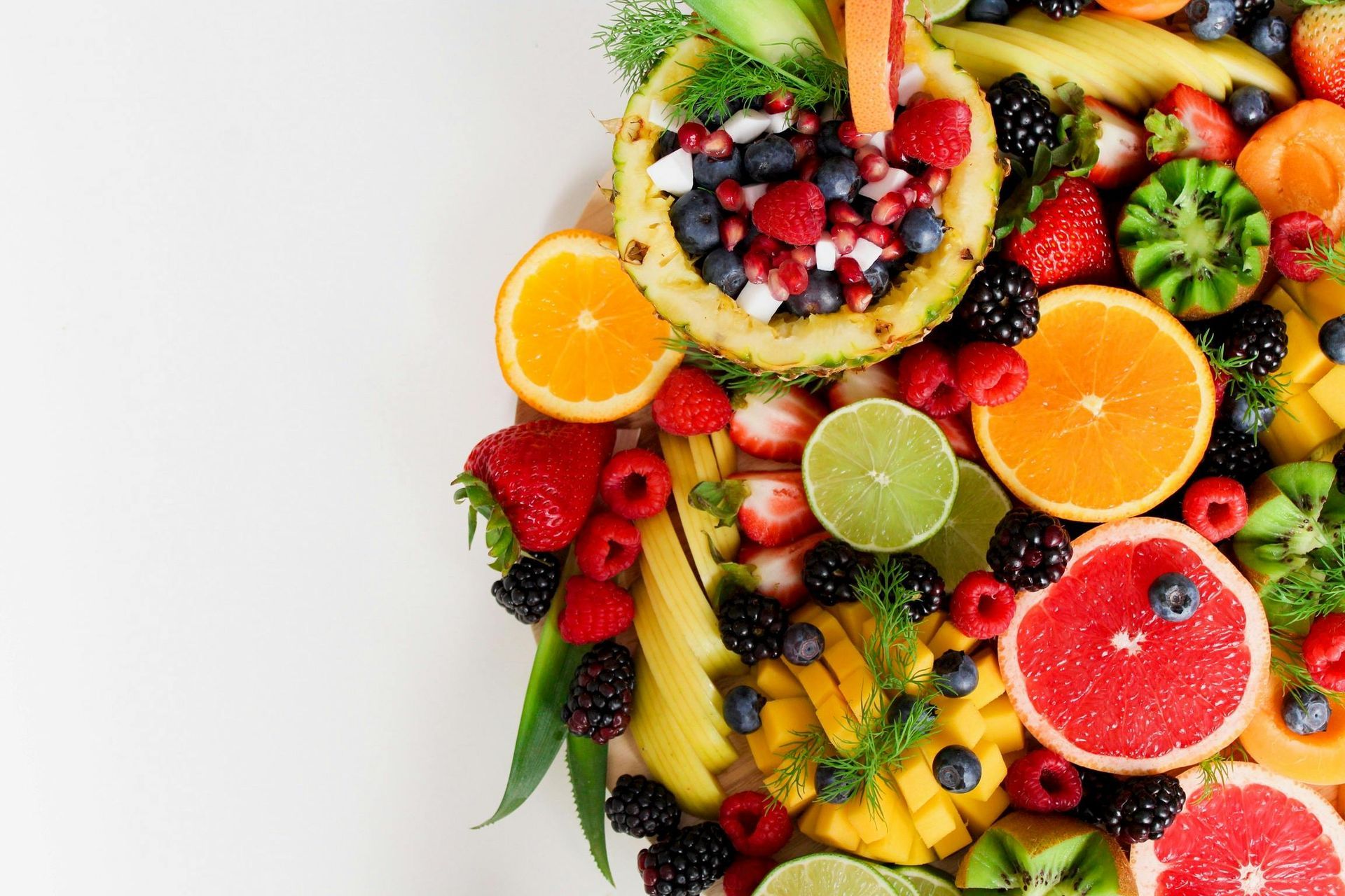 A white plate topped with a variety of fruits and vegetables.