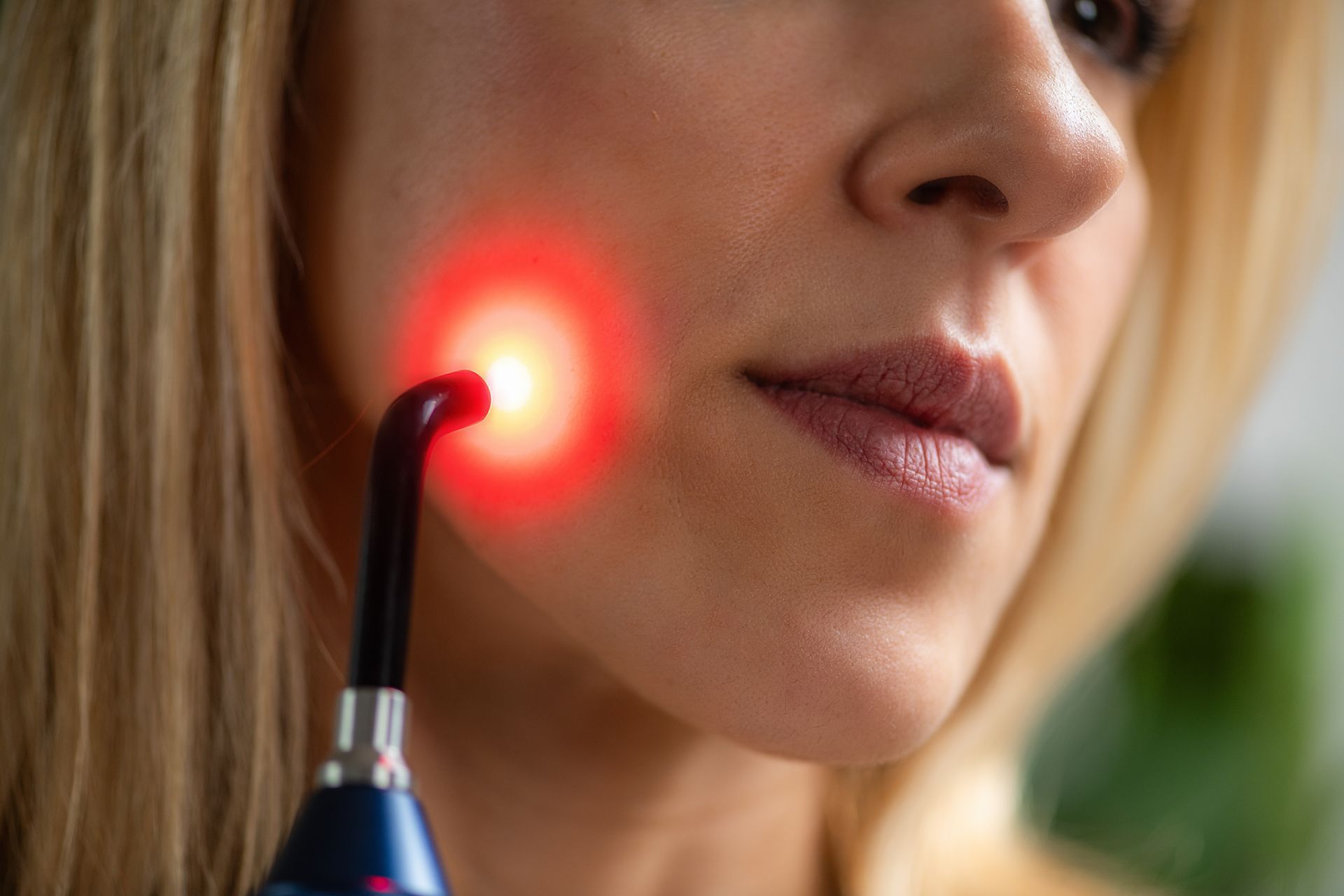 A woman is getting her teeth examined by a dentist in a dental office.