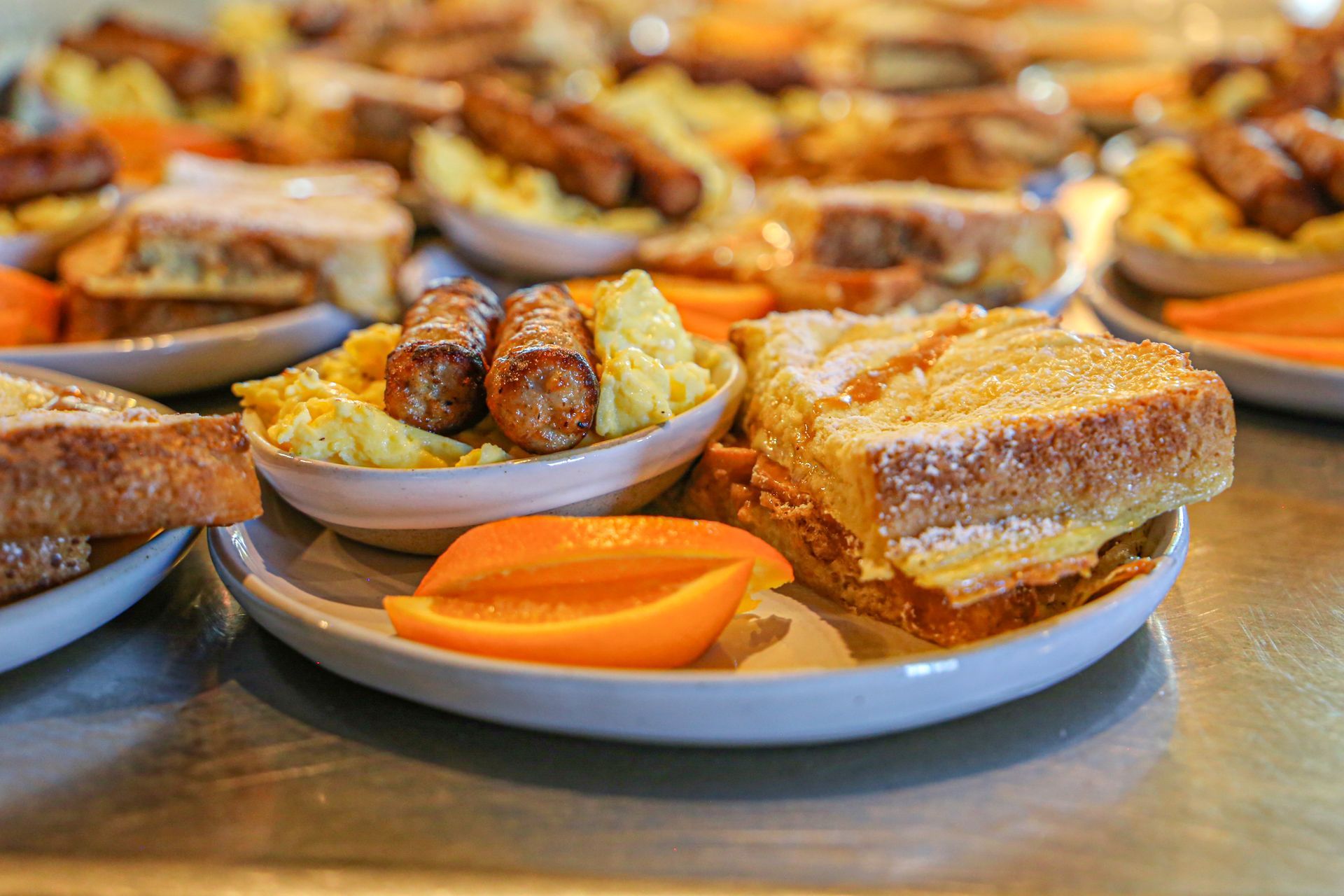 There are many different types of food on the plates on the table.