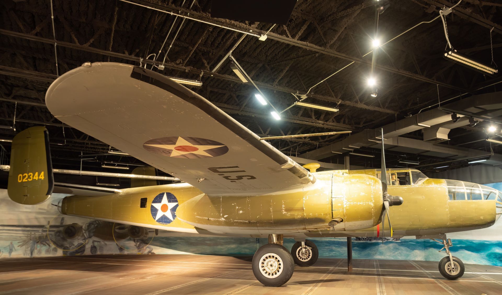 A small u.s. airplane is parked in a hanger.