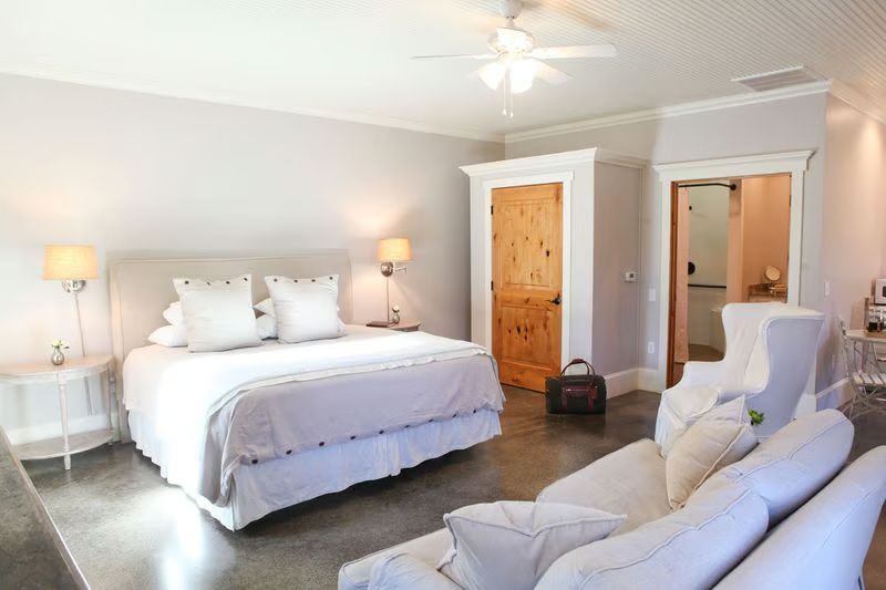 A bedroom with a king size bed and a couch