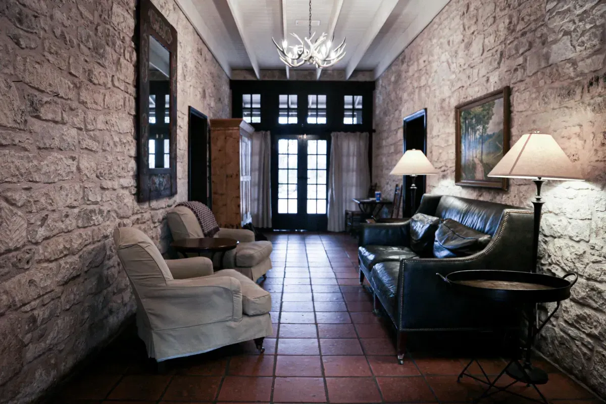 A long hallway with a couch and chairs in it