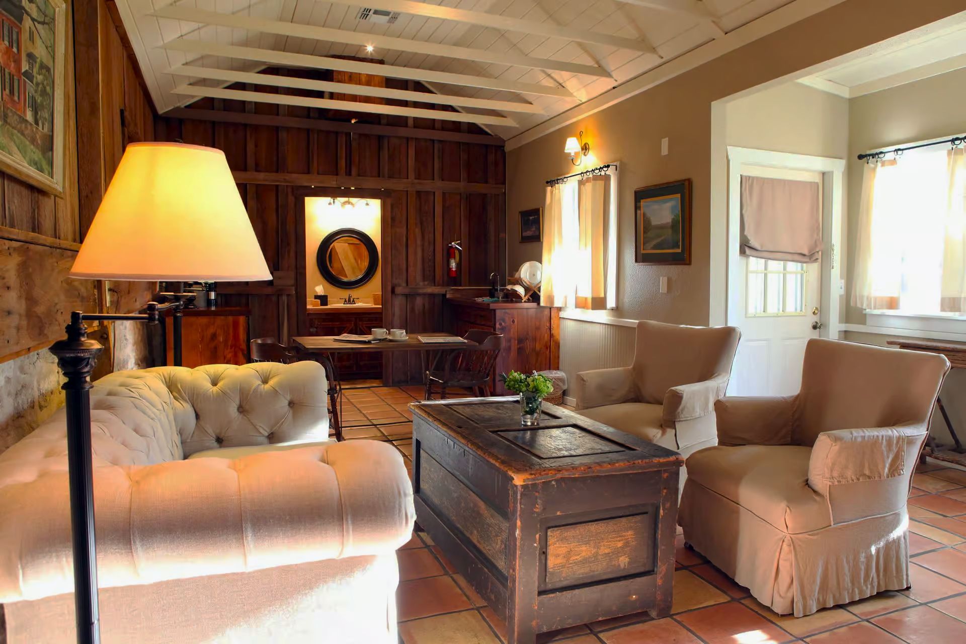 A living room with a couch and chairs and a coffee table