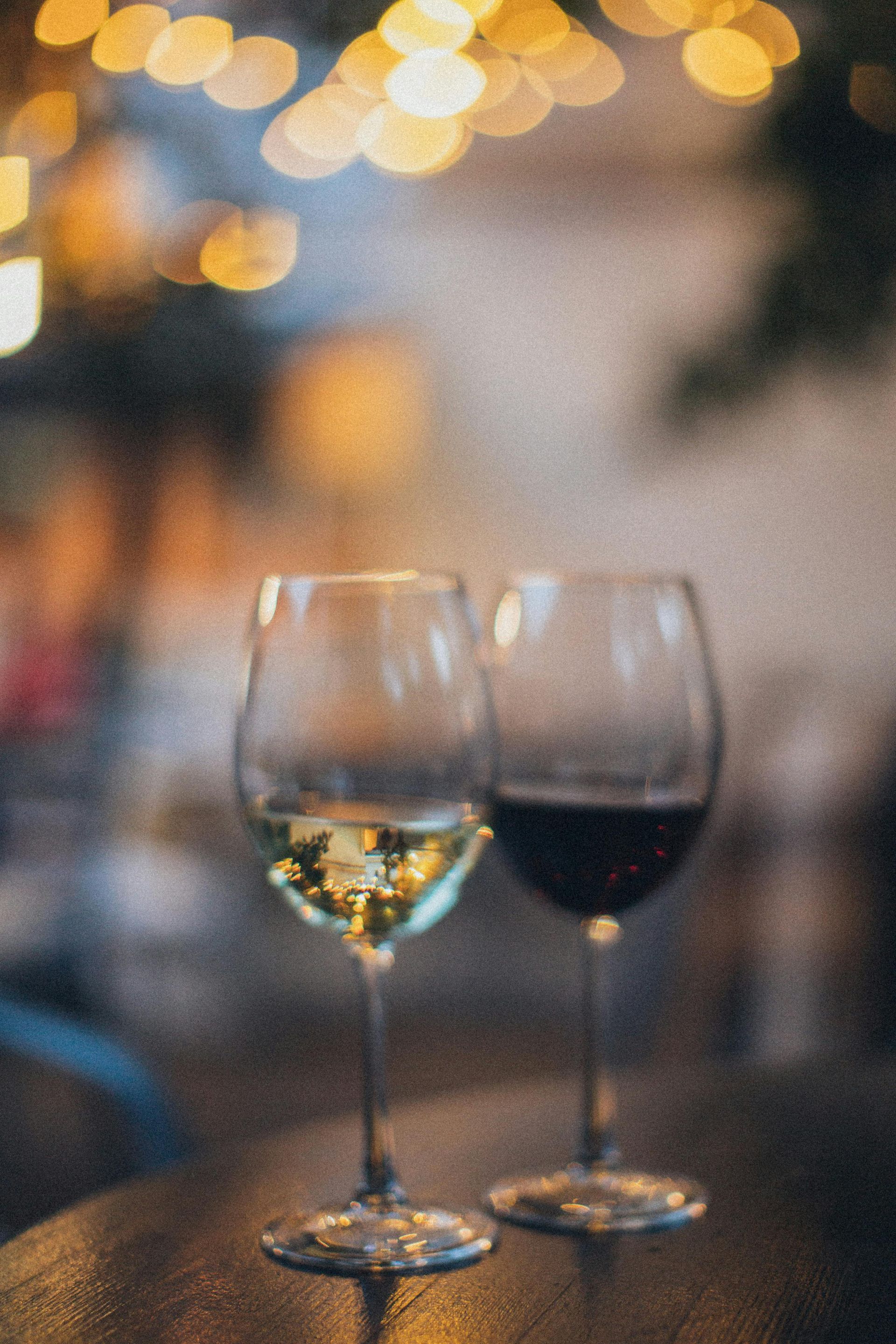 Two glasses of wine are sitting on a table.