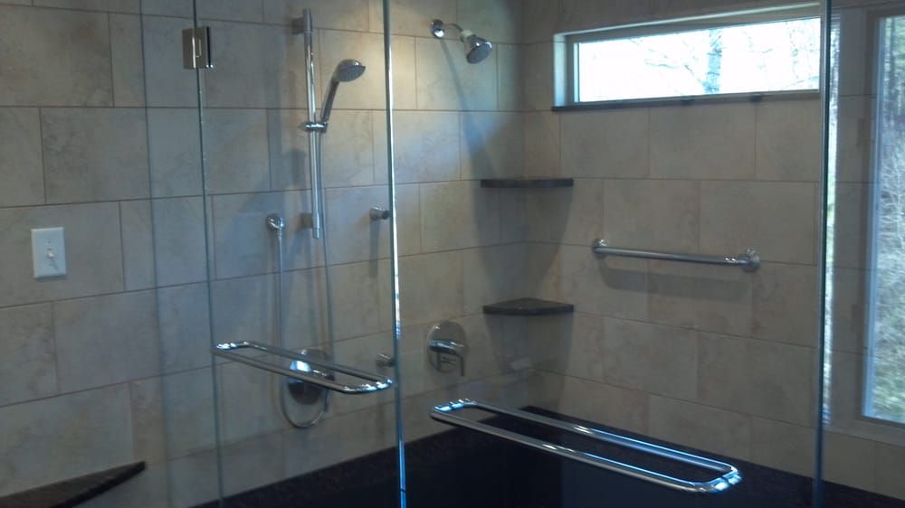 a bathroom with a walk in shower and a window