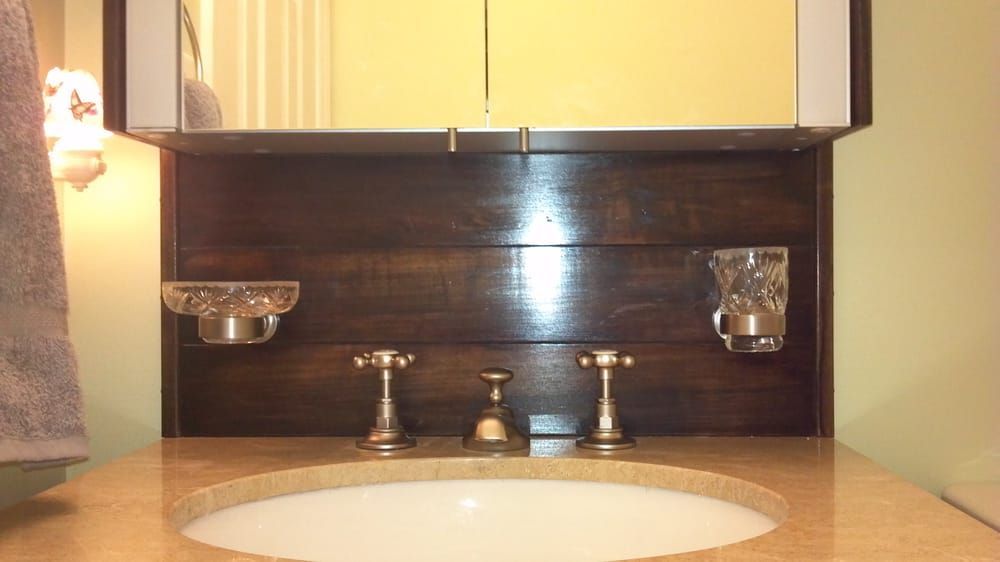 a bathroom sink with a mirror above it