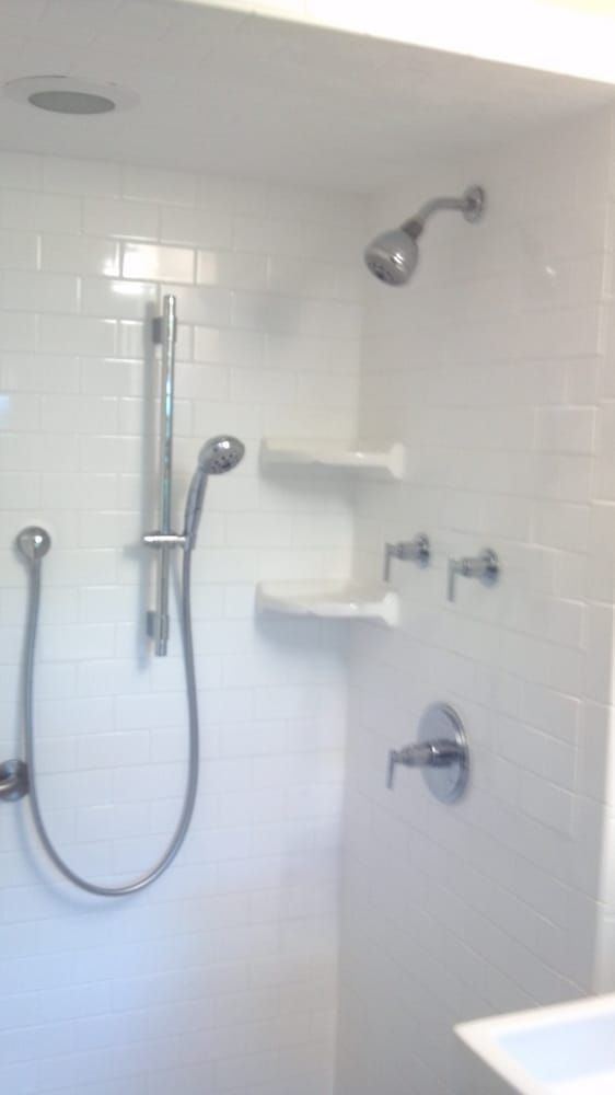 a bathroom with a shower head and a sink