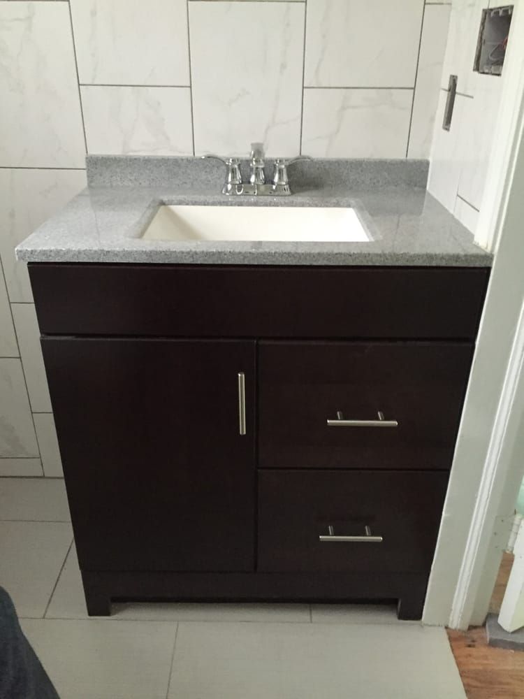 a bathroom vanity with a sink and drawers