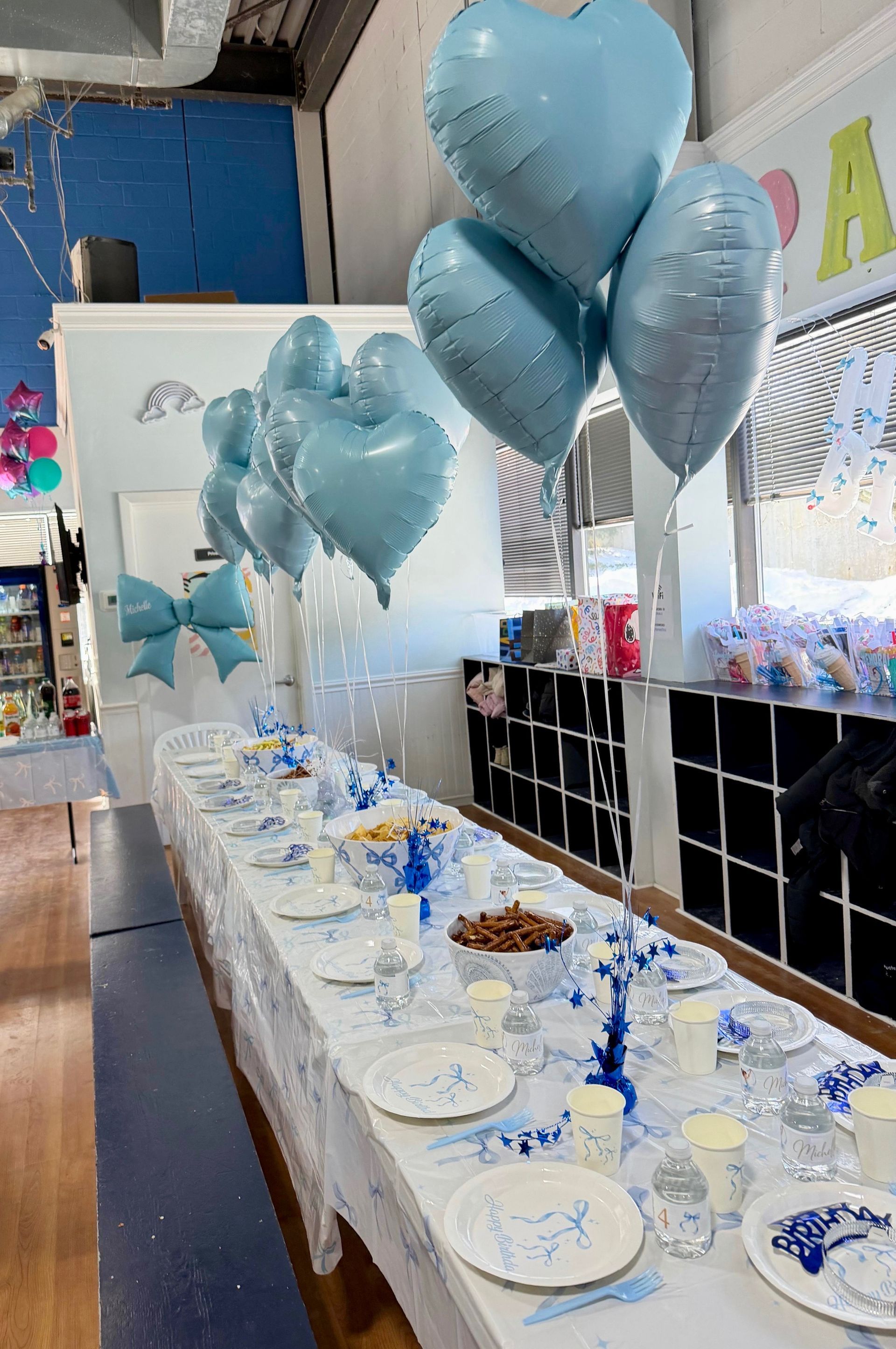 A group of children are celebrating a birthday with a cake and presents