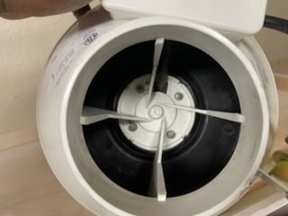 White inline duct fan with four blades inside a circular housing.