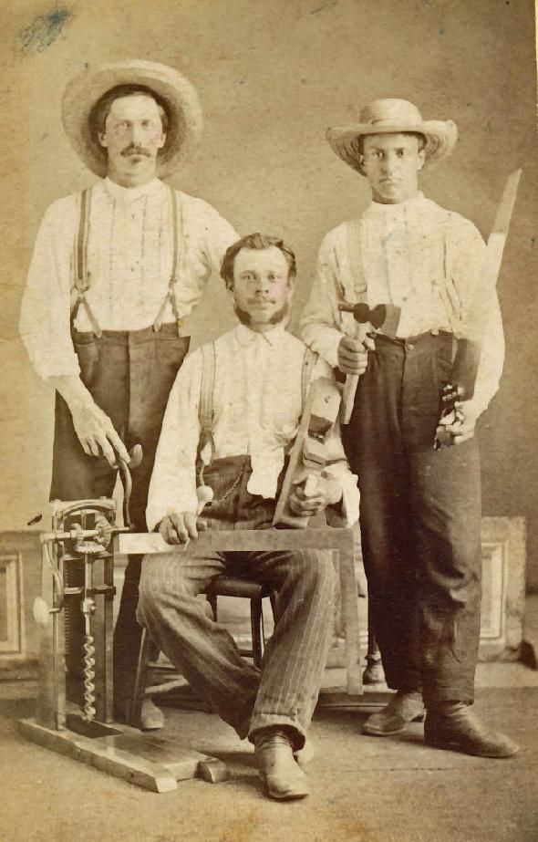 3 men holding hand tools