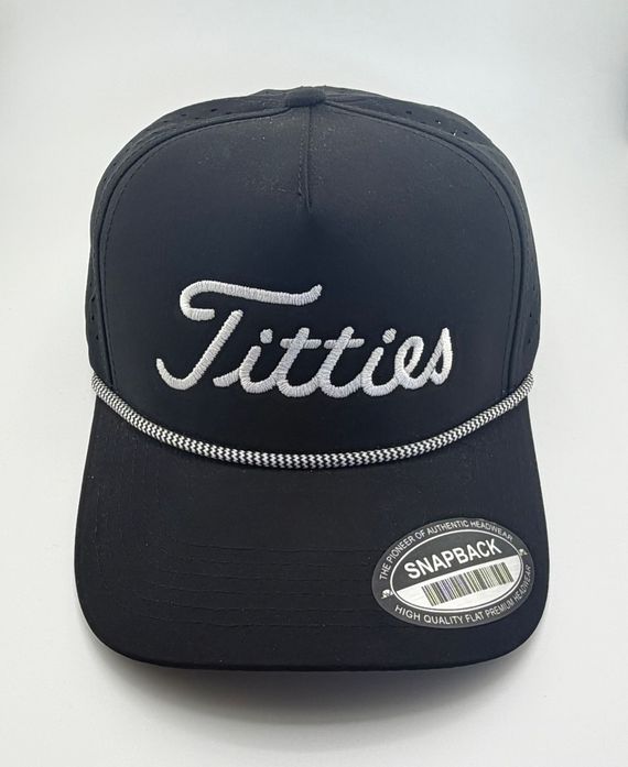 A black snapback cap with silver script embroidery reading 