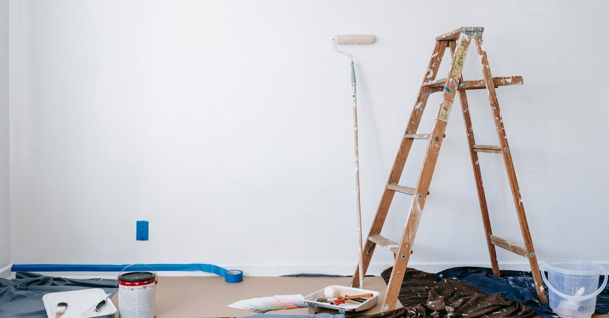 A room is being painted with a ladder and paint roller.