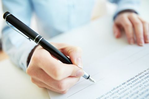 Businessman touching pen—bond insurance in County, MN