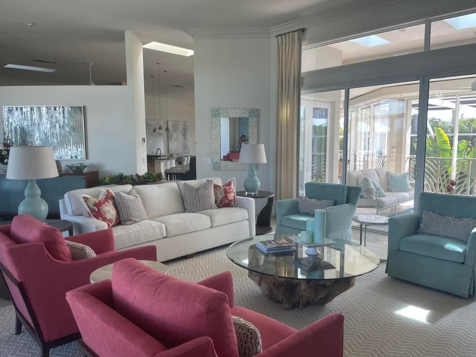 A living room with a white couch and blue chairs