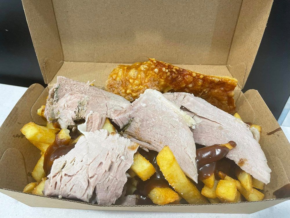 A Cardboard Box Filled With Meat and French Fries — Carpenter Carvery in Wendouree, VIC