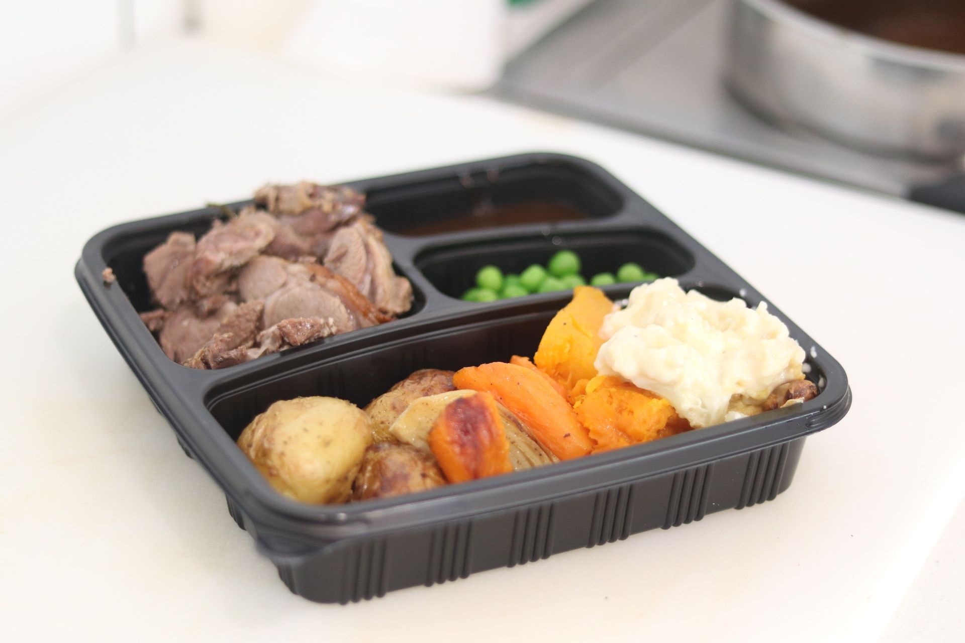 A Plastic Container Filled With Meat, Potatoes, Carrots, Peas and Mashed Potatoes — Carpenter Carvery in Wendouree, VIC
