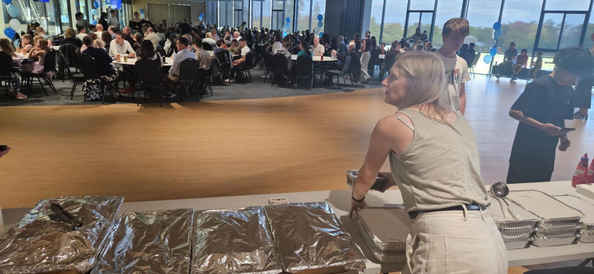A Woman is Standing in Front of a Table With Plates of Food — Carpenter Carvery in Wendouree, VIC