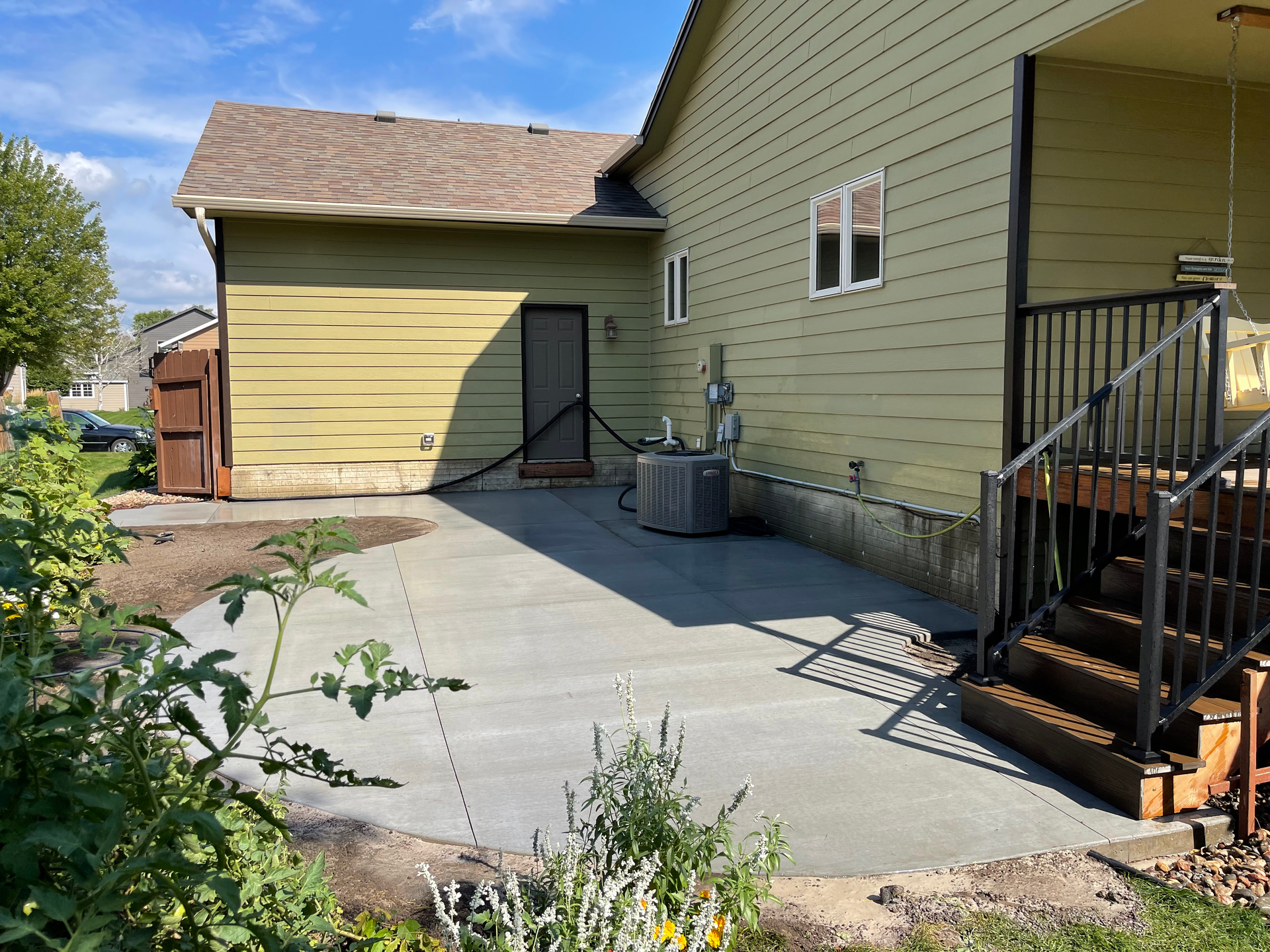 A house with a patio and stairs in front of it