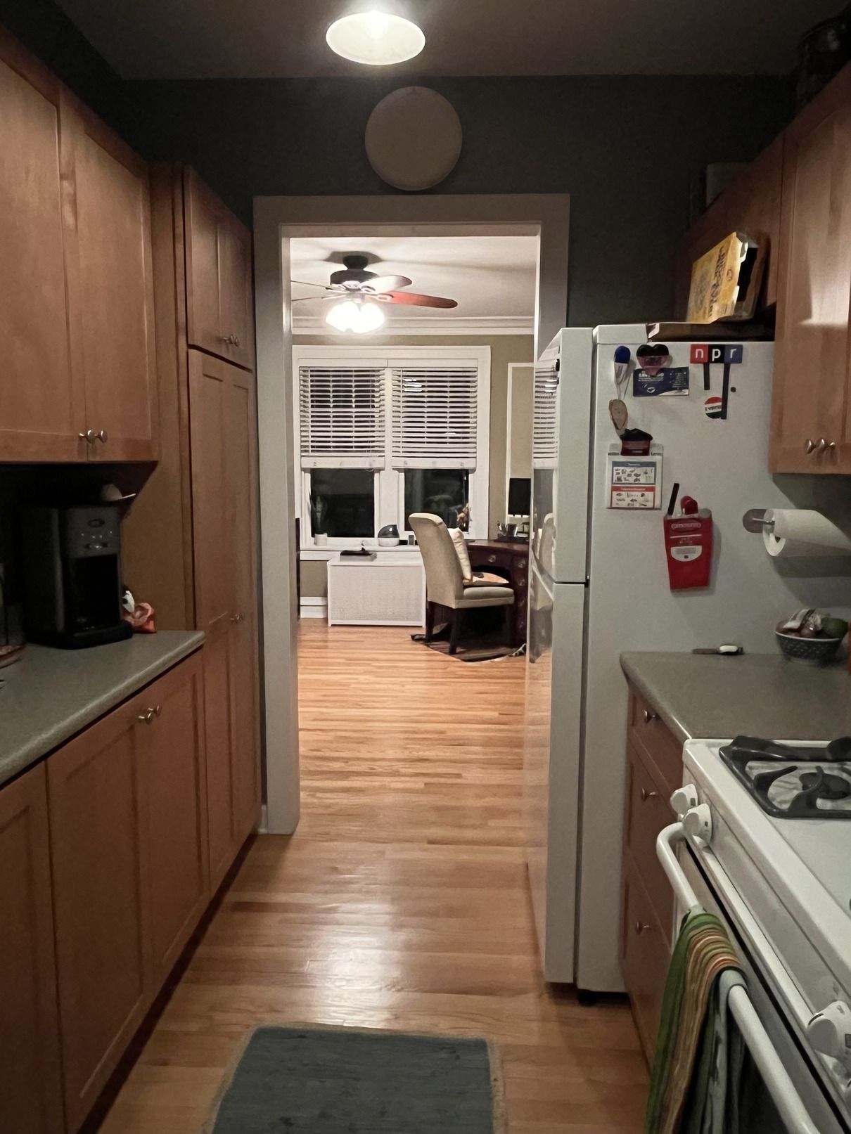 A kitchen with wooden cabinets and a white refrigerator