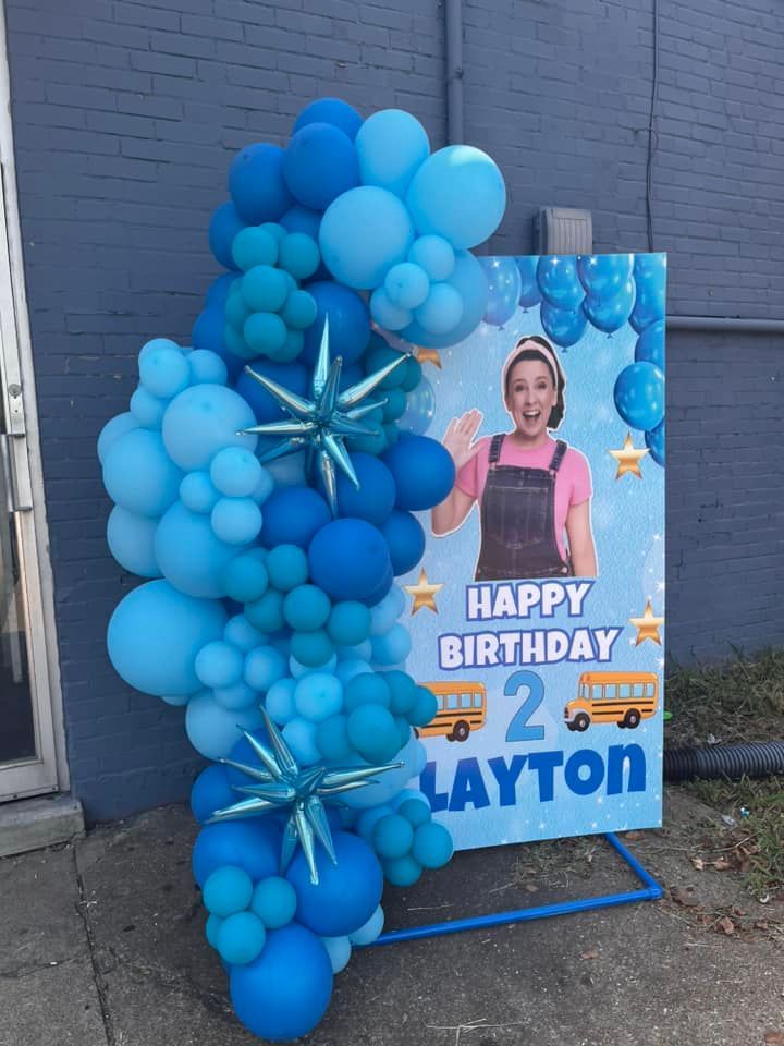 A sign that says happy birthday 2 layton is surrounded by blue balloons