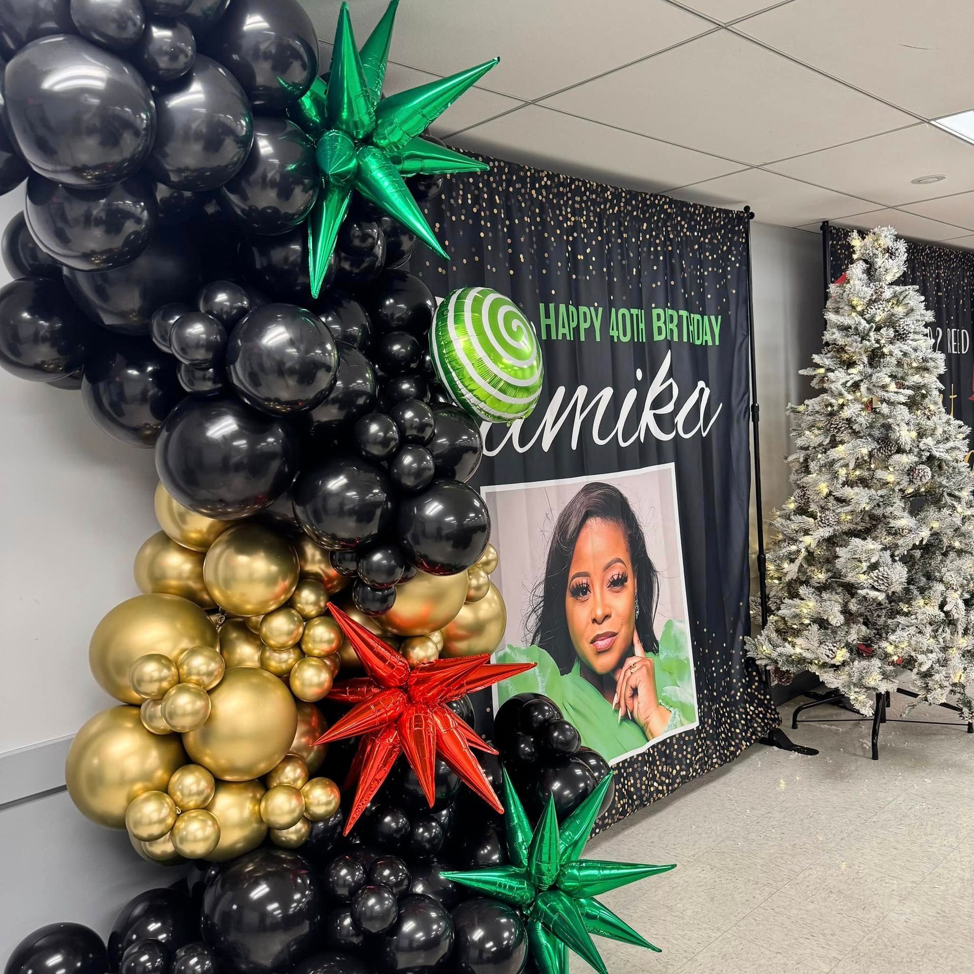 A room decorated with balloons and a picture of a woman