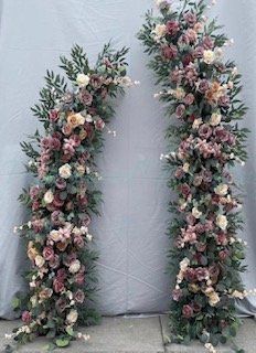 A couple of flowers sitting next to each other on a table.