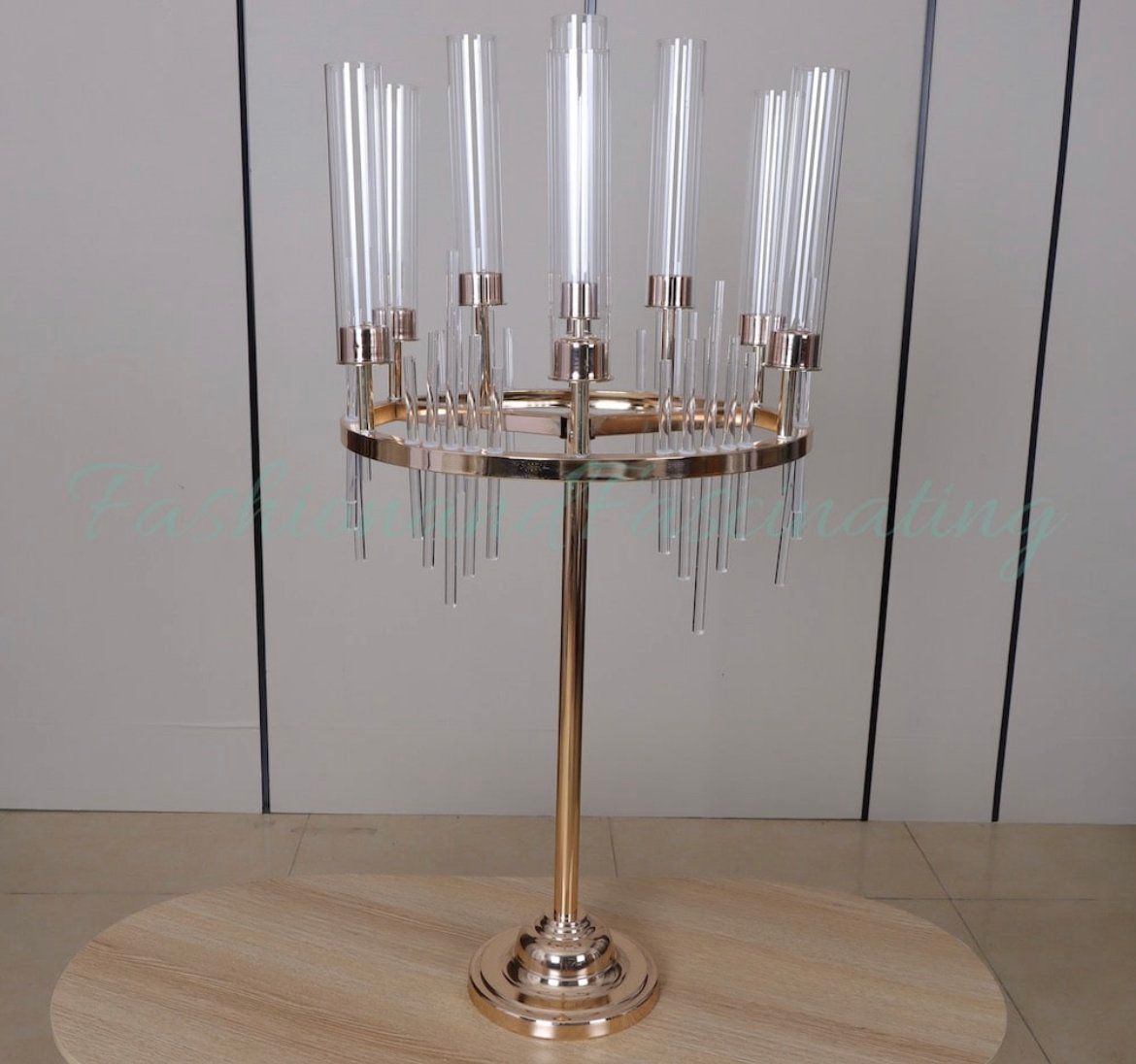 A gold candelabra with clear candles on a wooden table