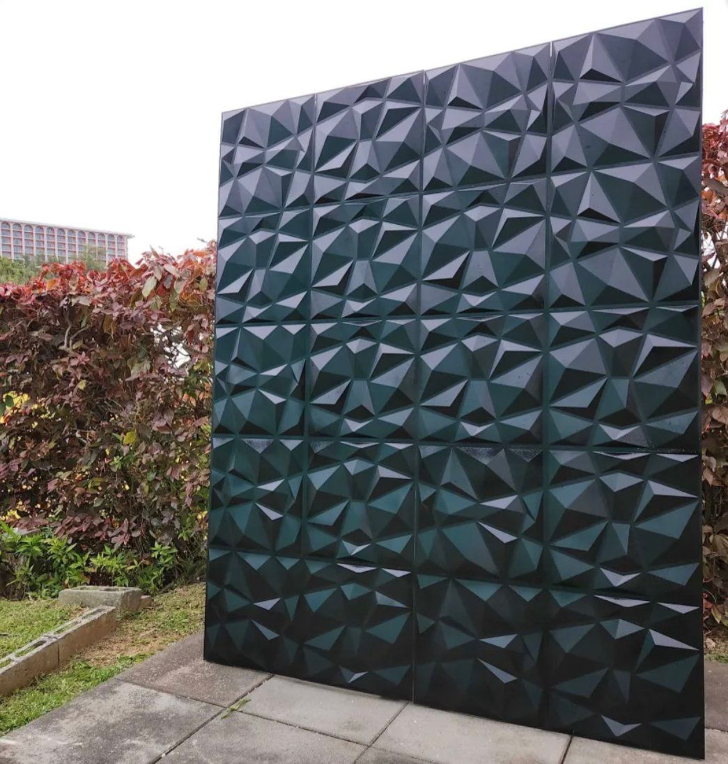 A large black wall with a geometric pattern on it