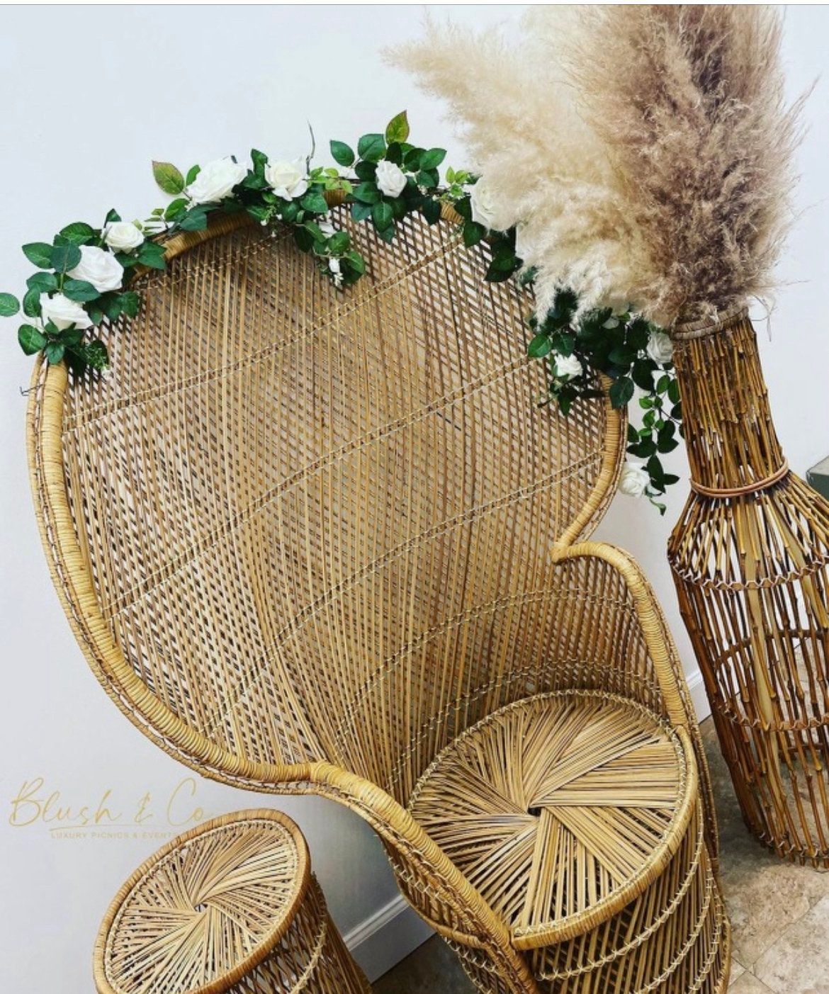 A wicker chair with a vase of flowers on it