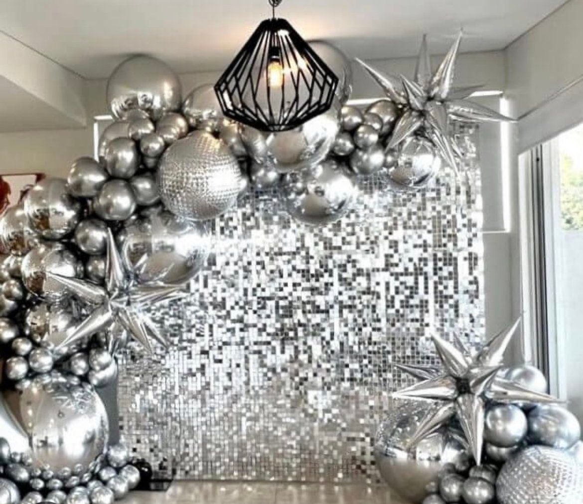 A room filled with lots of silver balloons and stars.