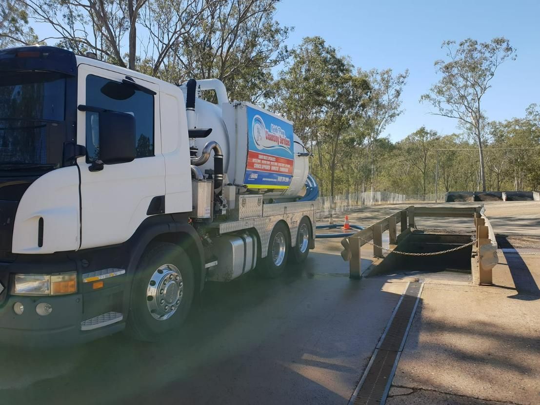 A White Vacuum Truck Is Parked On The Side Of The Road — Paap's Cleansing Services In Bundaberg, QLD
