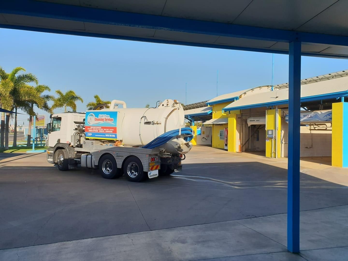 A White Truck Is Parked In A Parking Lot Next To A Building — Paap's Cleansing Services In Gin Gin, QLD