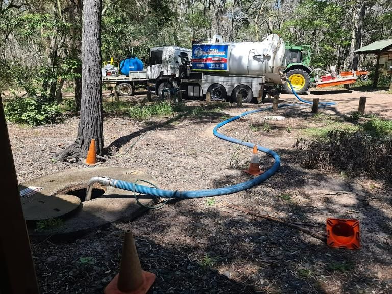 A Vacuum Truck Is Pumping Water Into A Septic Tank — Paap's Cleansing Services In Bundaberg, QLD