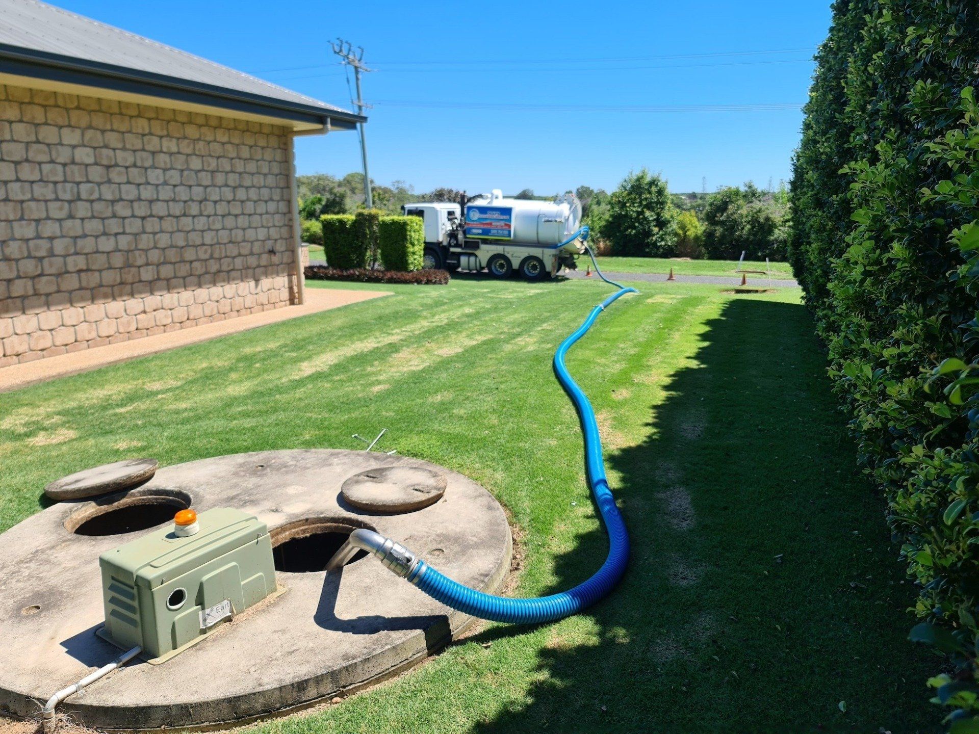 A Septic Tank Is Being Filled With Water By A Truck — Paap's Cleansing Services In Branyan, QLD