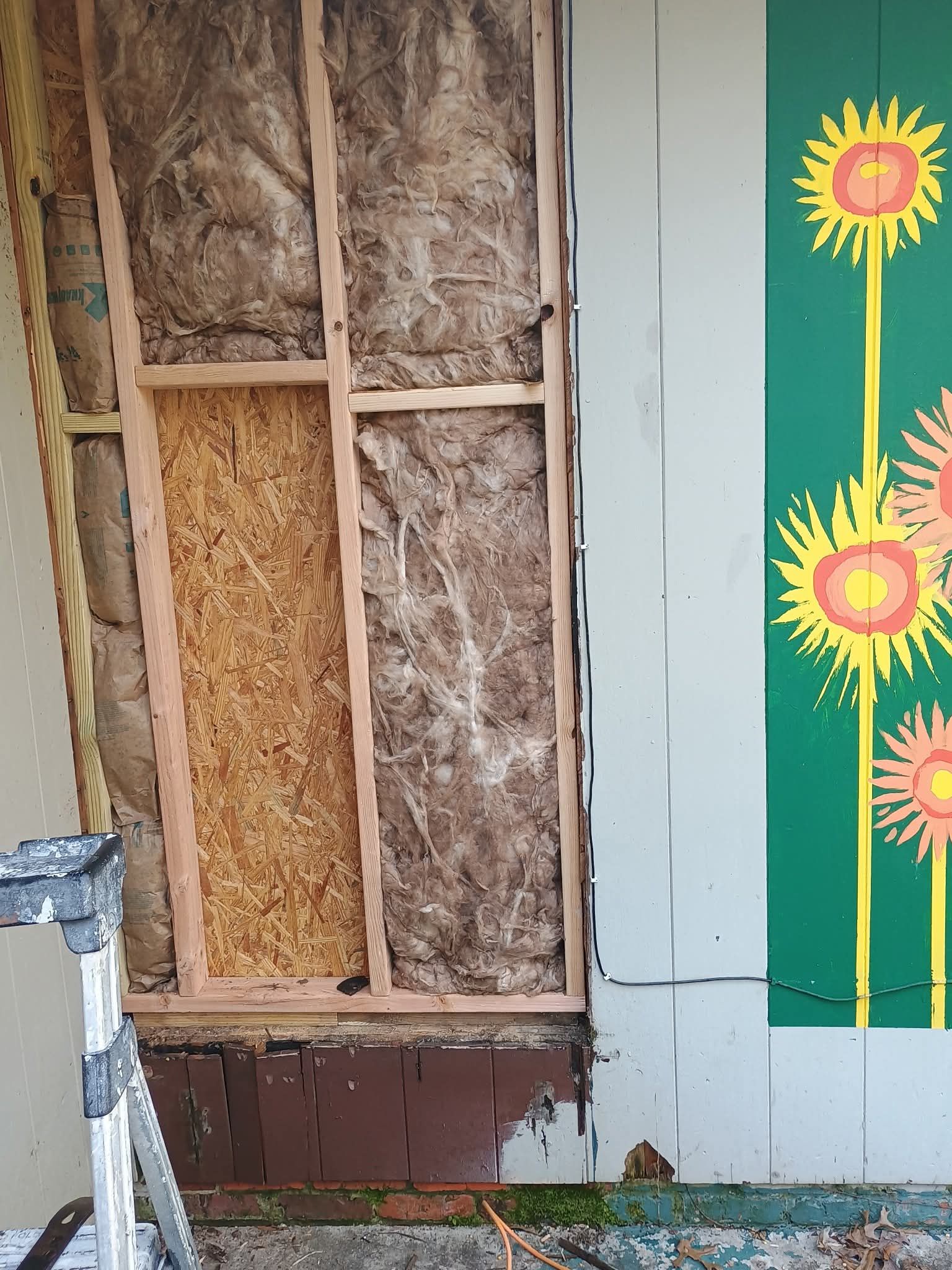 A wall with a picture of sunflowers on it
