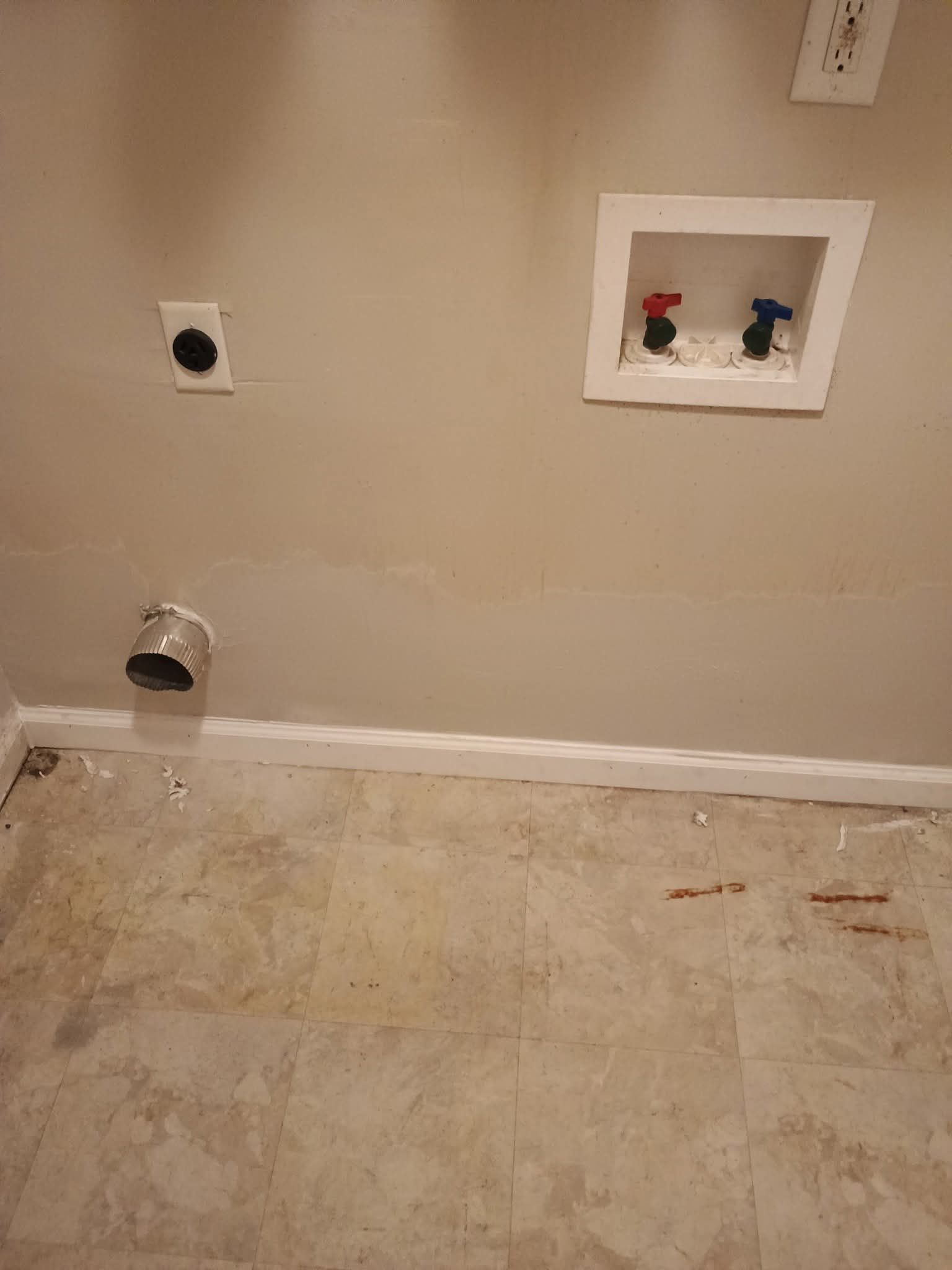 A bathroom with a sink and a washer and dryer.