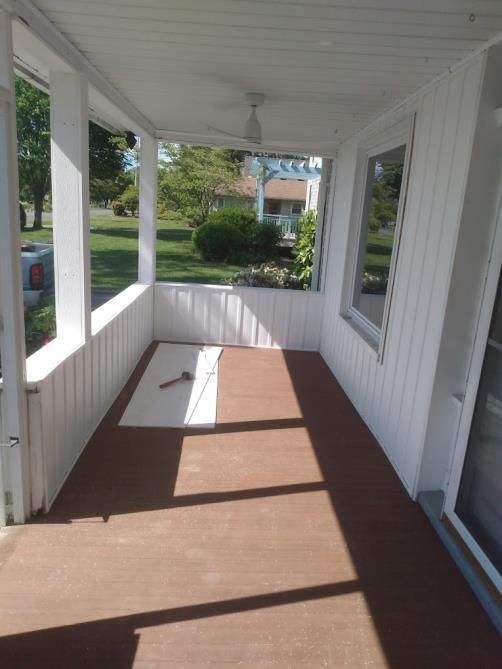 A porch with a hammer on the floor