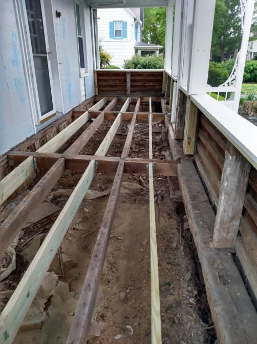 A wooden deck is being built on the side of a house.