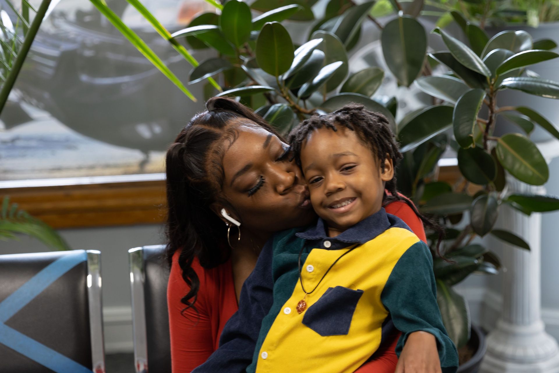 A photo of a woman kissing a child