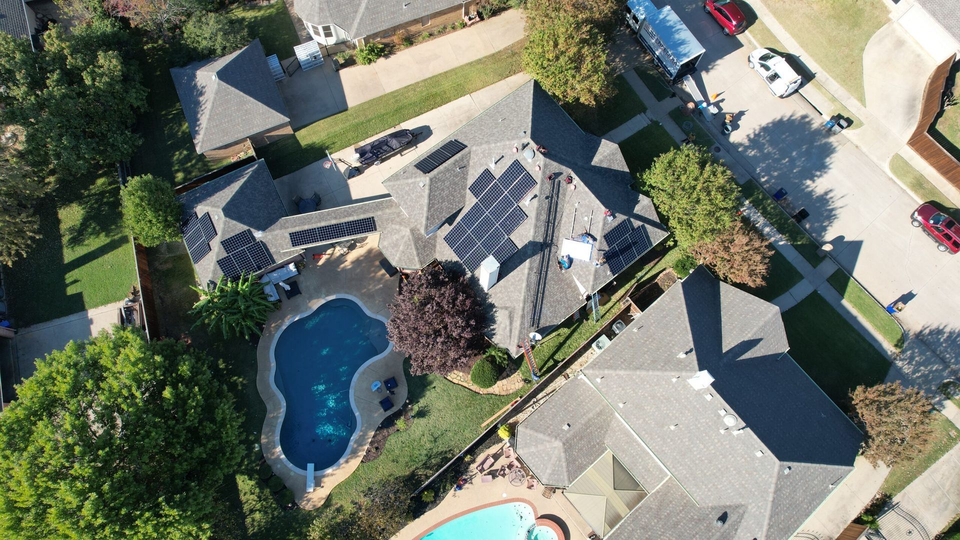 Aerial view of a house with solar panels on the roof