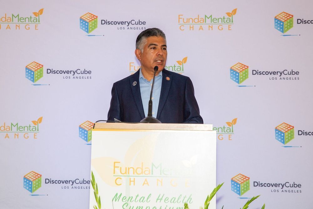 Man speaking at a podium with