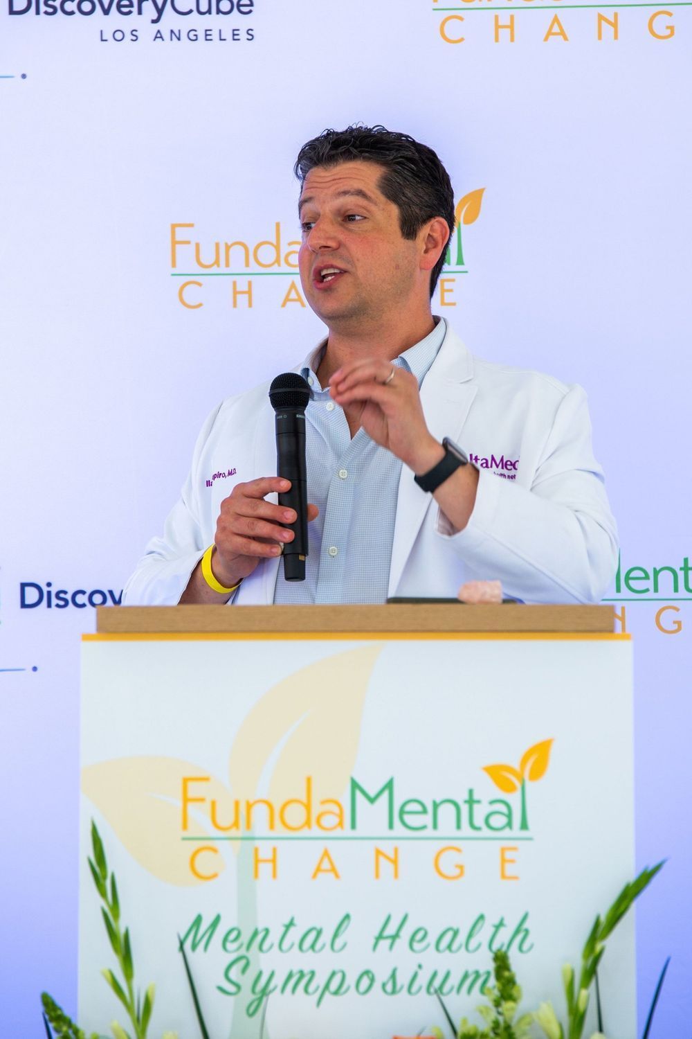 Man speaking at a podium with