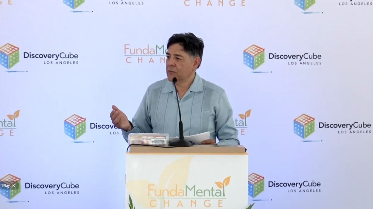 Person speaking at a podium with 