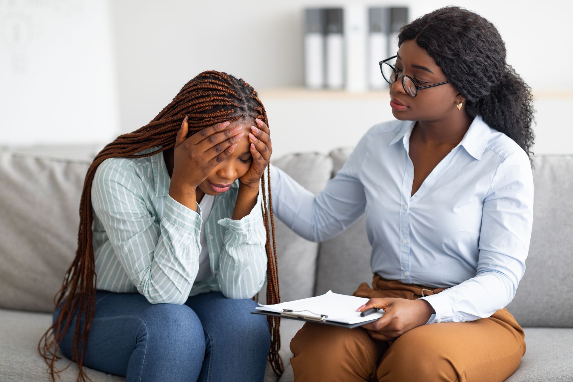 A woman is with a grief counselor. A woman is with a grief counselor.