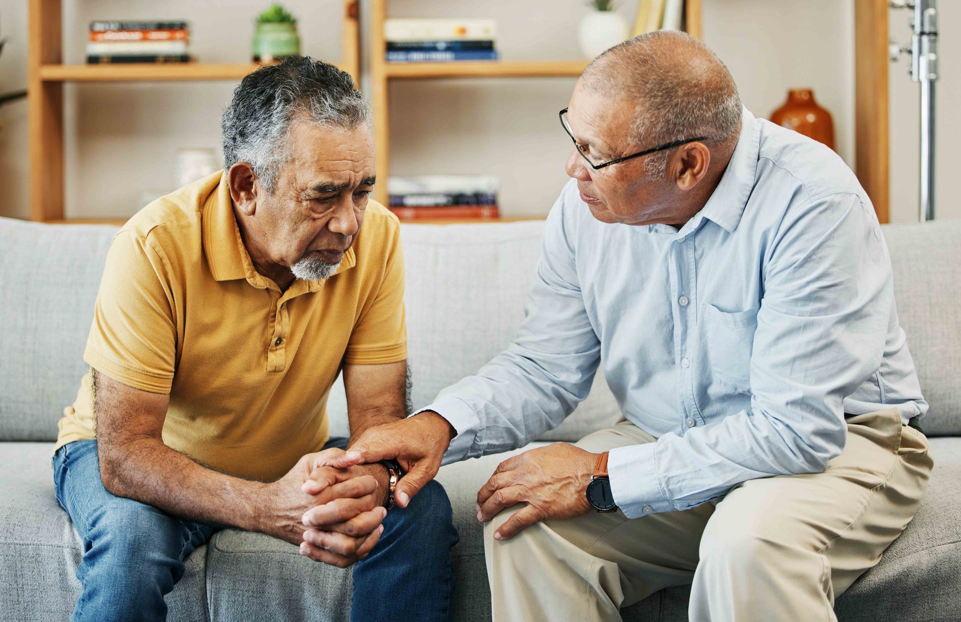Elderly men having a conversation with a grief counselor.