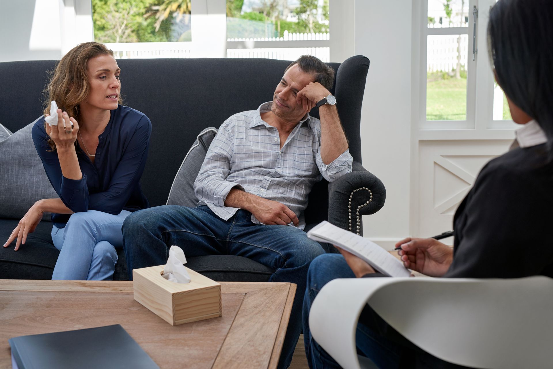 A Caucasian couple in a marriage counseling session, receiving professional relationship guidance. A Caucasian couple in a marriage counseling session, receiving professional relationship guidance.