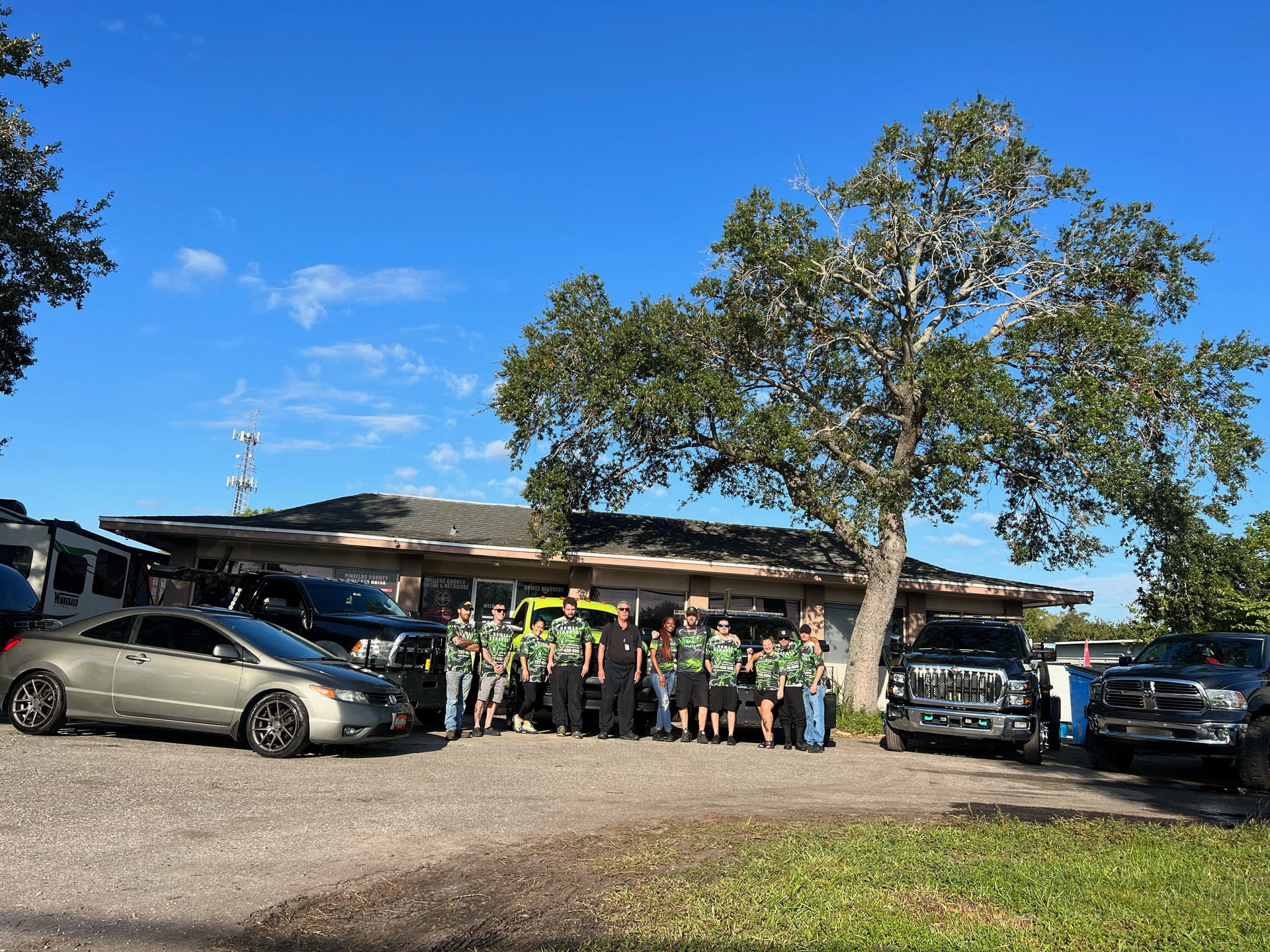 A group of people are posing for a picture in front of a house.